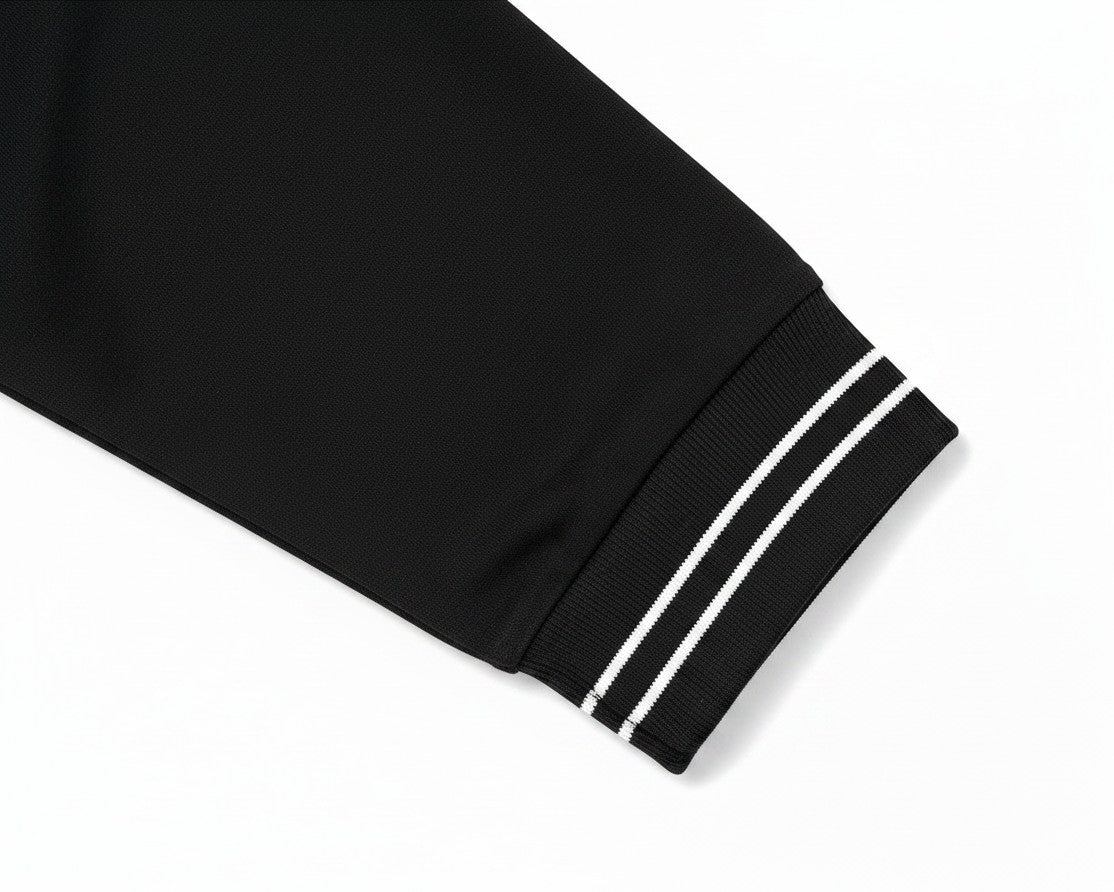 PAKSHI black long sleeve polo shirt sleeve detail with ribbed cuffs featuring two white stripes