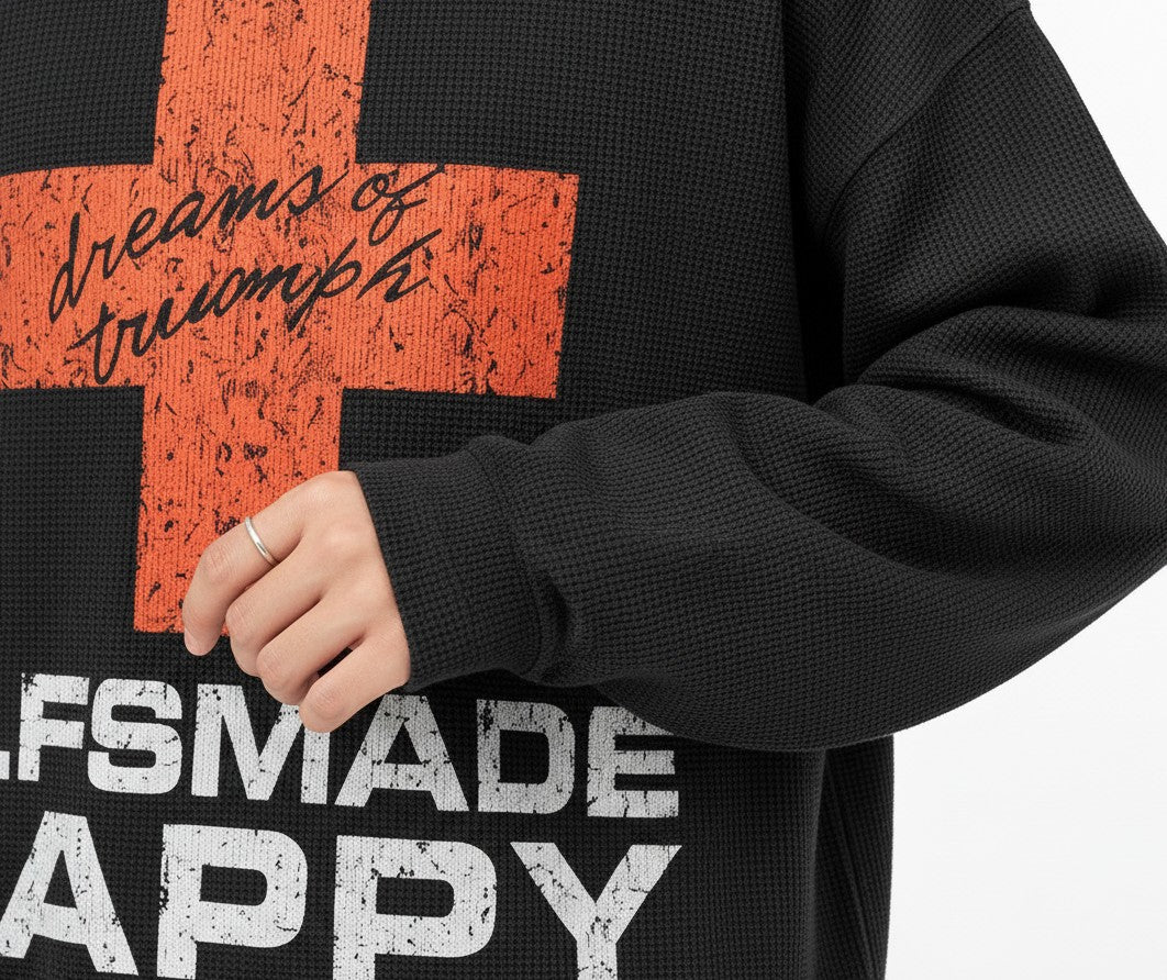 PAKSHI black waffle knit long-sleeve t-shirt with a distressed red cross graphic and white text detail