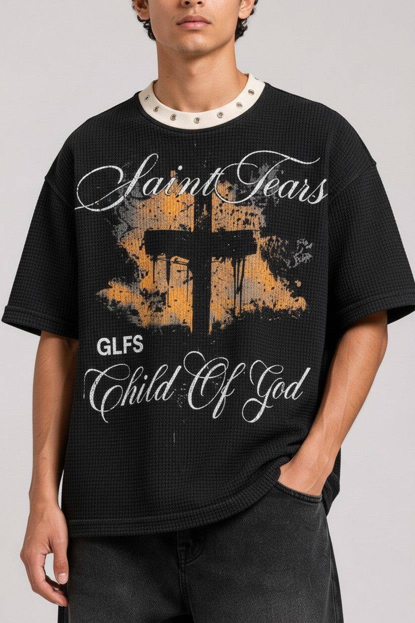 PAKSHI black waffle knit t-shirt with a distressed cross graphic, Saint Tears text, and a metal eyelet collar.