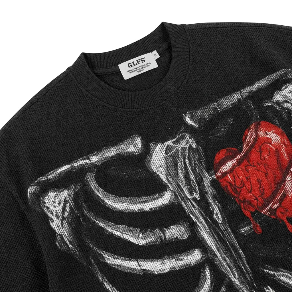 PAKSHI black waffle knit t-shirt featuring a white skeleton rib cage graphic and a detailed red melted heart design.