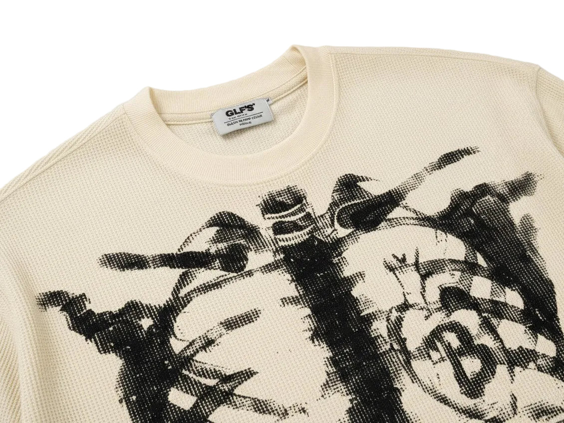 PAKSHI cream waffle knit long-sleeve t-shirt featuring a black distressed skeleton graphic print on the chest.