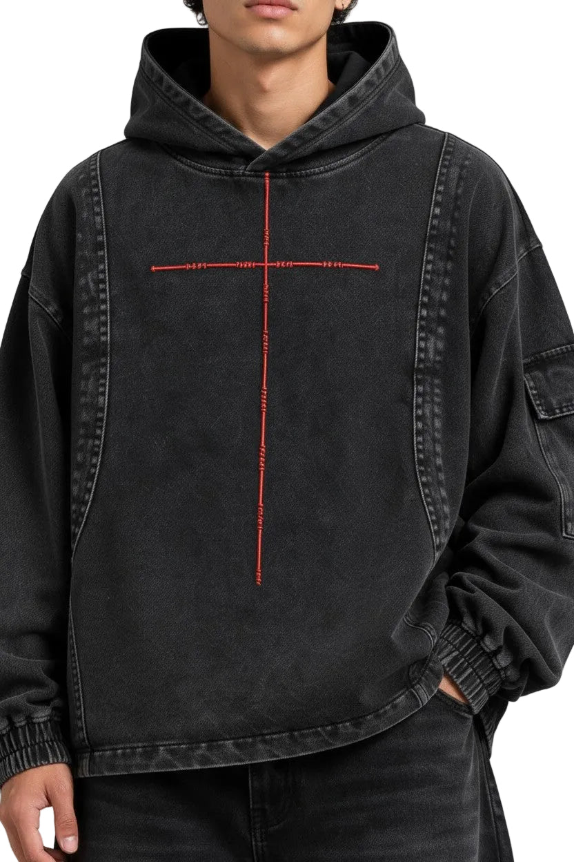 PAKSHI cropped black denim hoodie featuring a red cross embroidery and utility pocket on the sleeve