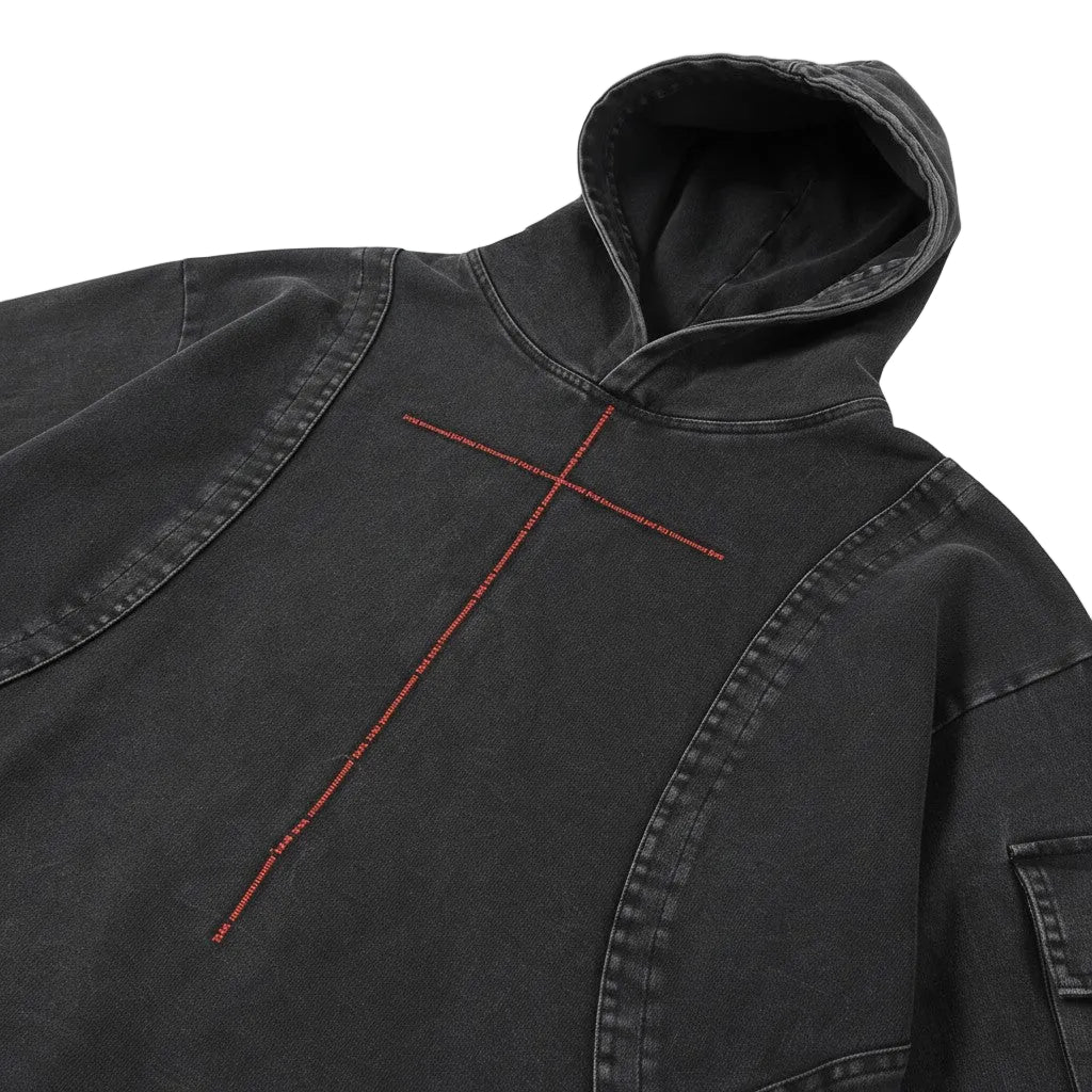 PAKSHI cropped utility denim hoodie in washed black with a red cross-stitch detail and hood.
