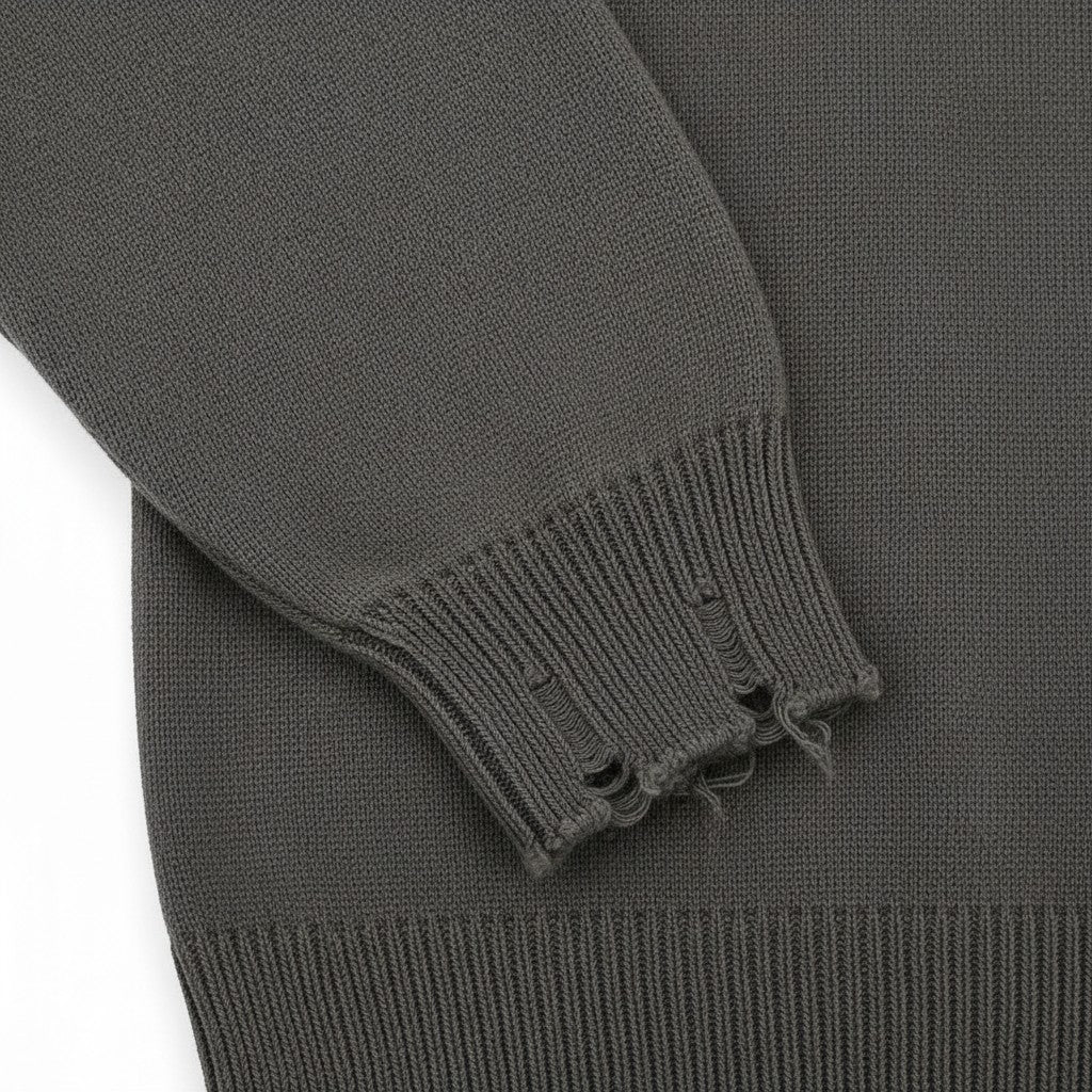 PAKSHI Y2K oversized grey knit sweater featuring a distressed frayed cuff detail on the long sleeve