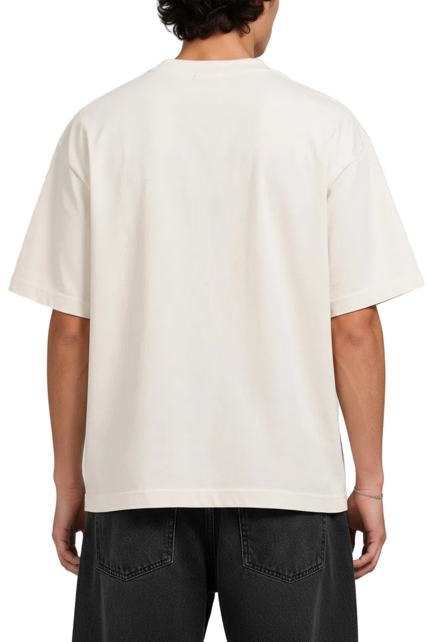 Back view of a man wearing a plain off-white PAKSHI oversized cotton t-shirt with black denim jeans