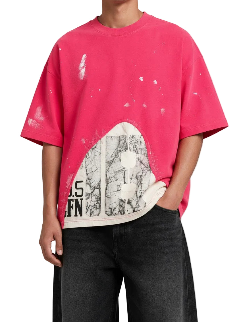 PAKSHI pink oversized t-shirt with white paint splatter, distressed hem, and graphic print panel on the front