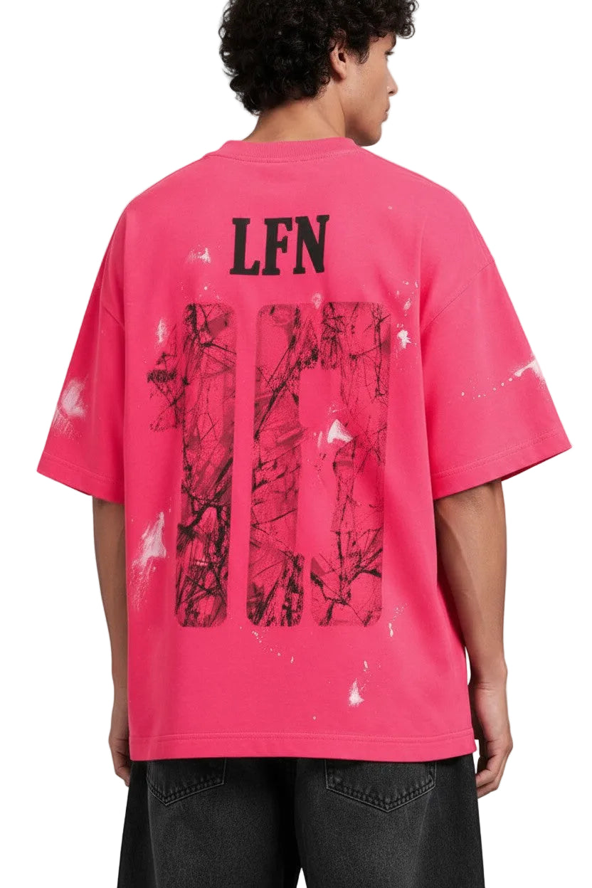 PAKSHI pink oversized t-shirt with black LFN graphic, distressed paint splatter detail, and back view on a model