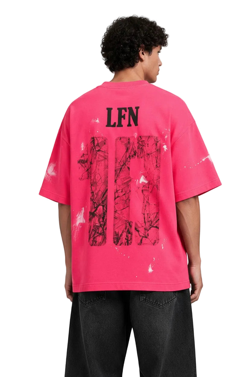 PAKSHI pink oversized t-shirt with black LFN graphic, distressed paint splatters, and back view on a male model