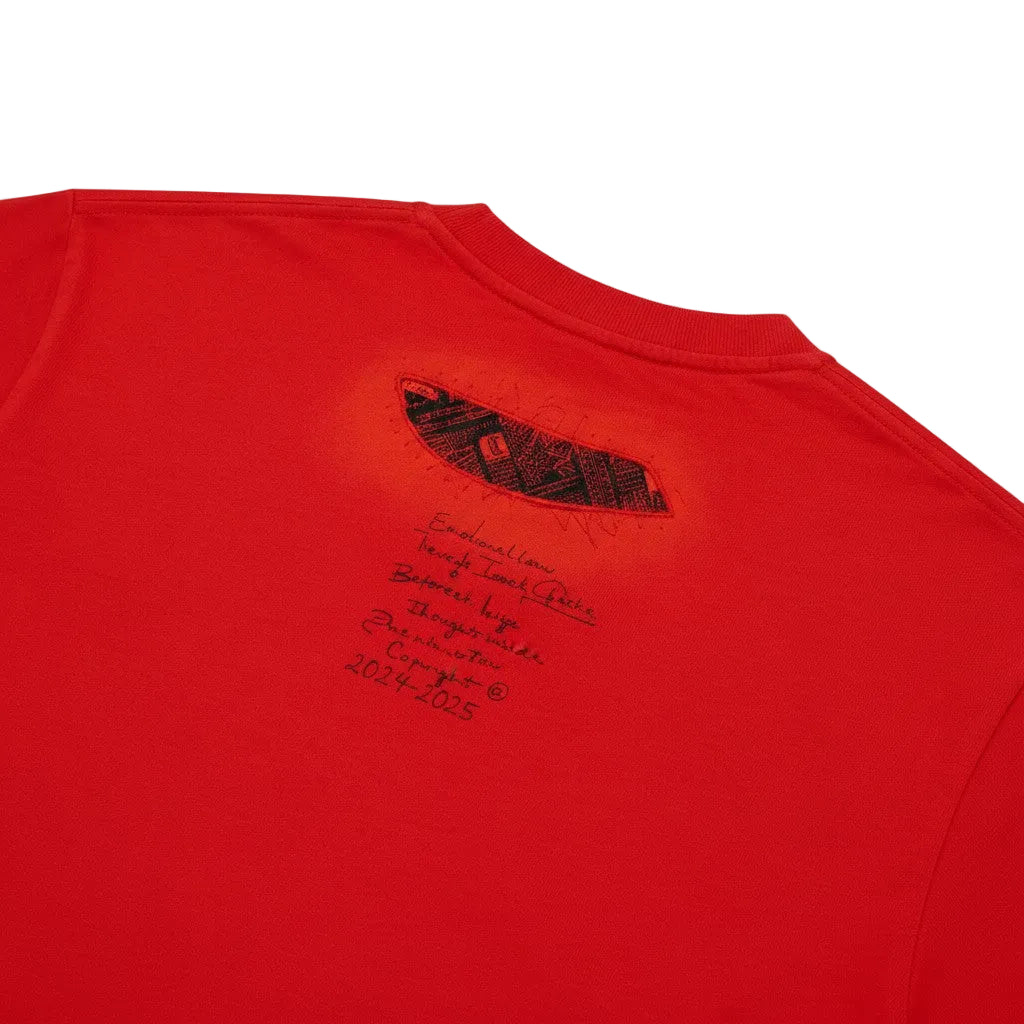 PAKSHI red cotton t-shirt featuring a black embroidered patchwork detail and printed text on the upper back
