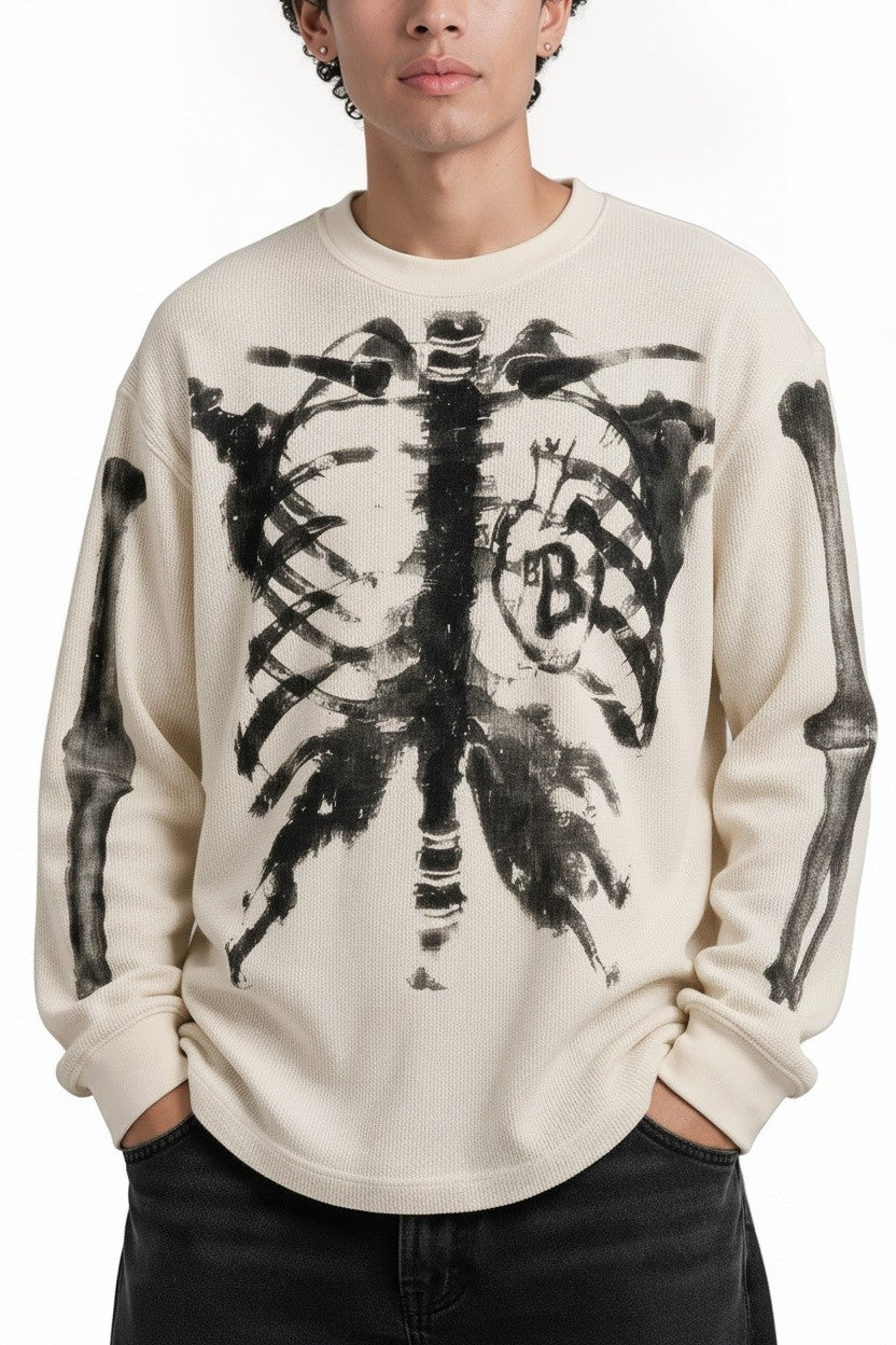 PAKSHI cream waffle knit long-sleeve t-shirt featuring a black distressed skeleton rib cage graphic print