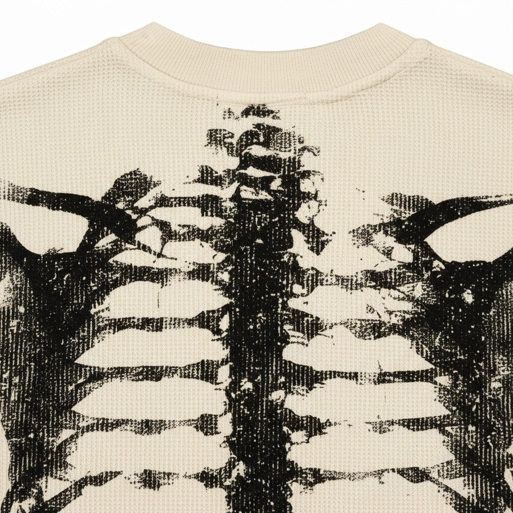 PAKSHI waffle knit long-sleeve t-shirt in beige featuring a distressed black skeleton rib cage graphic print